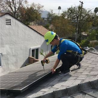 Intern on roof with solar panels